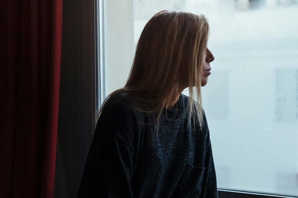 first night, woman looking out window