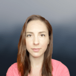 A woman with light skin and straight brown hair wearing a pink shirt looks directly at the camera against a gradient gray-blue background.